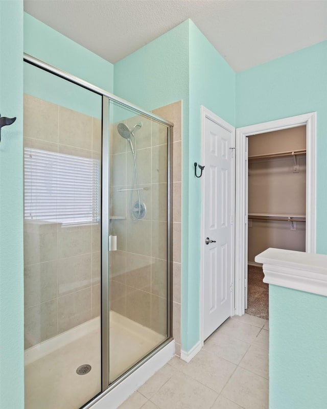 5365 Saba Dr, Fort Worth, TX 76119 - full bath featuring tile patterned flooring, a stall shower, and a walk in closet