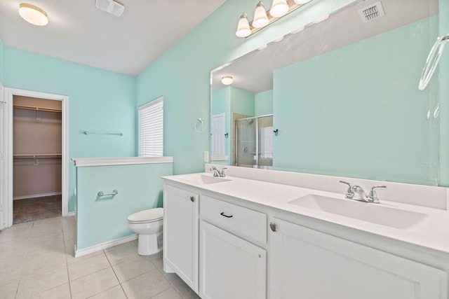 5365 Saba Dr, Fort Worth, TX 76119 - bathroom with a shower stall, tile patterned floors, double vanity, and a spacious closet