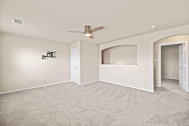 5365 Saba Dr, Fort Worth, TX 76119 - empty room featuring carpet, ceiling fan, and arched walkways
