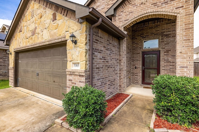 5365 Saba Dr, Fort Worth, TX 76119 - entrance to property with a garage, brick siding, driveway, and stone siding