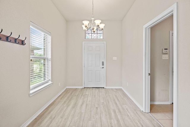 5365 Saba Dr, Fort Worth, TX 76119 - foyer entrance featuring a chandelier and light wood finished floors