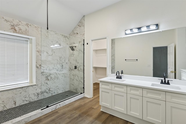 9942 Laurel Ln, Frisco, TX 75035 - full bath featuring a marble finish shower, wood finished floors, double vanity, a spacious closet, and lofted ceiling