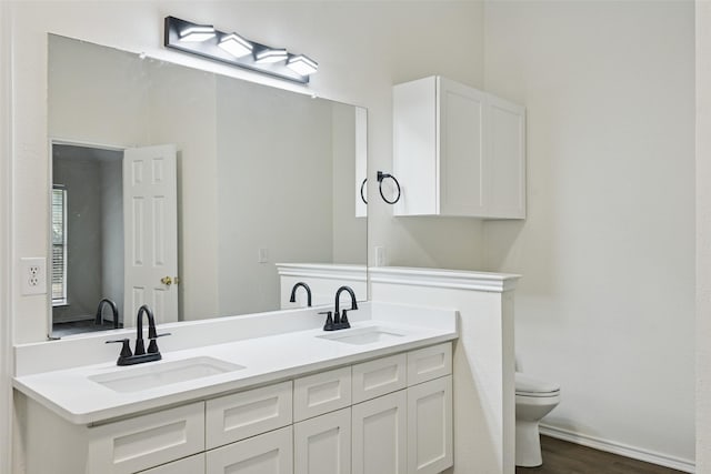 9942 Laurel Ln, Frisco, TX 75035 - bathroom with double vanity and wood finished floors