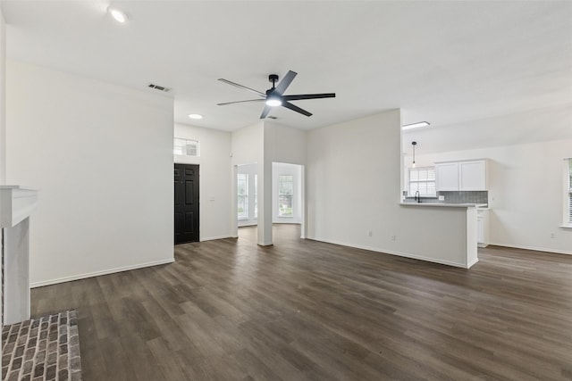 9942 Laurel Ln, Frisco, TX 75035 - unfurnished living room with dark wood finished floors, a ceiling fan, and recessed lighting