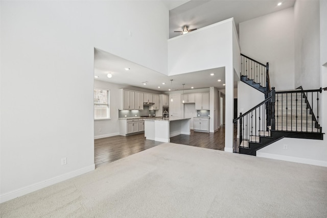 3516 Hathaway Ct, Irving, TX 75062 - living area featuring dark colored carpet, stairway, a ceiling fan, recessed lighting, and a towering ceiling