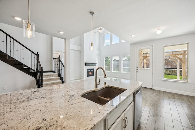3516 Hathaway Ct, Irving, TX 75062 - kitchen featuring a tile fireplace, decorative light fixtures, dishwasher, light stone counters, and recessed lighting
