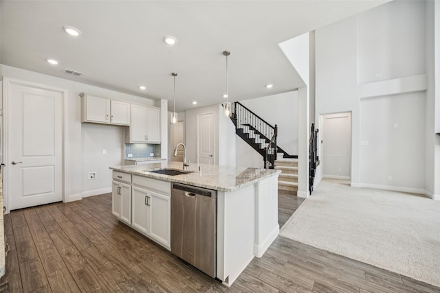 3516 Hathaway Ct, Irving, TX 75062 - kitchen with dishwasher, wood finished floors, light stone countertops, white cabinetry, and recessed lighting