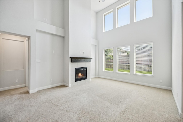 3516 Hathaway Ct, Irving, TX 75062 - unfurnished living room featuring a towering ceiling, carpet, and a fireplace