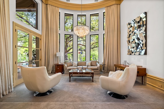 14516 Winnwood Rd, Addison, TX 75254 - living area featuring carpet floors, a towering ceiling, and a chandelier