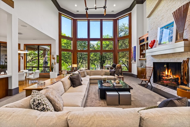 14516 Winnwood Rd, Addison, TX 75254 - living area featuring a high ceiling, ornamental molding, a fireplace, a chandelier, and carpet flooring