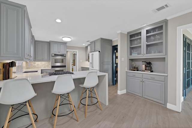 6375 Lansdale Rd, Fort Worth, TX 76116 - kitchen with gray cabinetry, stainless steel double oven, a peninsula, white fridge with ice dispenser, and recessed lighting