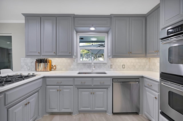 6375 Lansdale Rd, Fort Worth, TX 76116 - kitchen with gray cabinets, appliances with stainless steel finishes, tasteful backsplash, light countertops, and crown molding