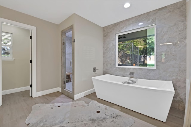 6375 Lansdale Rd, Fort Worth, TX 76116 - full bath with a freestanding bath, tile walls, a stall shower, and wood finished floors
