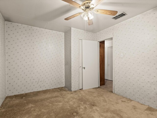 415 S Union St, Montague, TX 76251 - spare room featuring carpet floors, wallpapered walls, and a ceiling fan