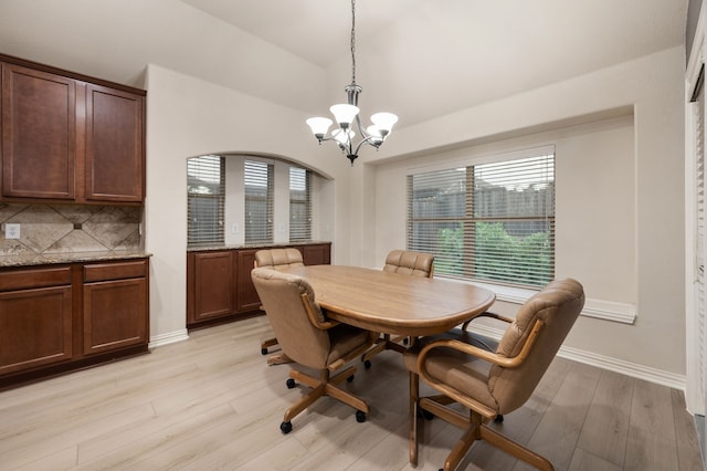 8225 Courtney Way, Watauga, TX 76148 - dining area with a chandelier, lofted ceiling, and light wood-type flooring