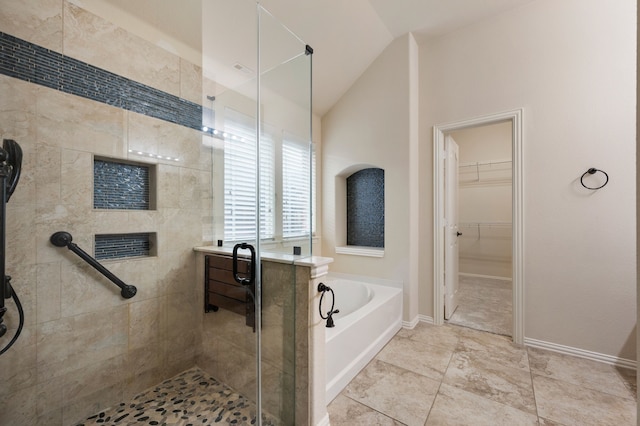 8225 Courtney Way, Watauga, TX 76148 - bathroom with a shower stall, a bath, vaulted ceiling, and a walk in closet