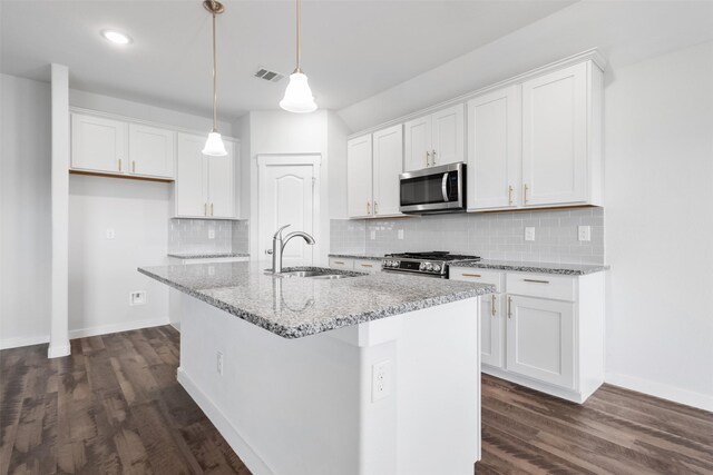 6112 Fall Creek Ln, Fort Worth, TX 76123 - kitchen with stainless steel appliances, dark wood-type flooring, white cabinetry, and recessed lighting