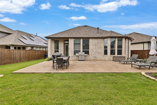 1429 Arrowwood Dr, Aubrey, TX 76227 - rear view of house featuring a fenced backyard, a patio area, brick siding, and roof with shingles