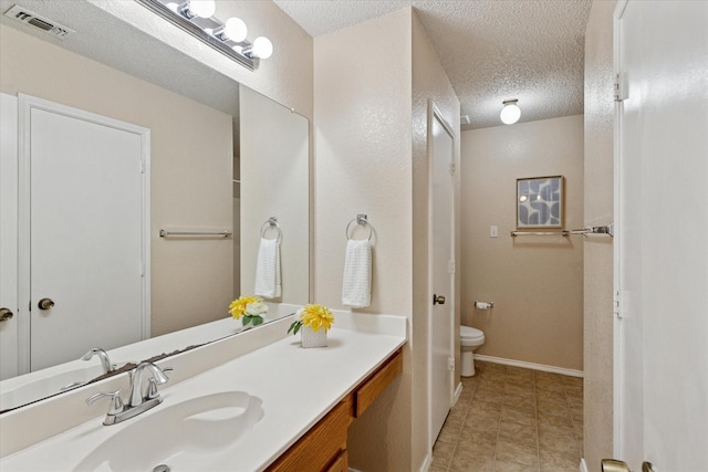 2611 Winding Rd, Fort Worth, TX 76133 - bathroom featuring a textured ceiling, vanity, and tile patterned floors