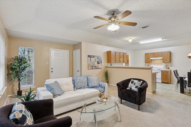 2611 Winding Rd, Fort Worth, TX 76133 - living area featuring a textured ceiling, ceiling fan, and light carpet