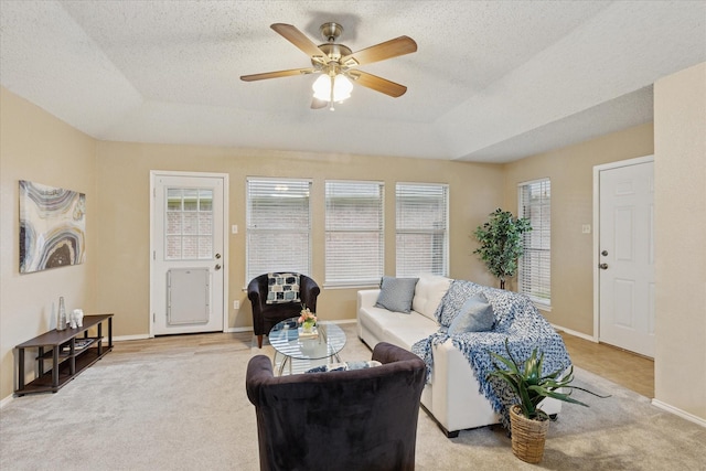 2611 Winding Rd, Fort Worth, TX 76133 - living room featuring a raised ceiling, healthy amount of natural light, light carpet, and a textured ceiling