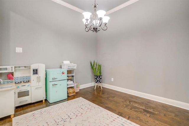 201 Saxon St, Waxahachie, TX 75165 - game room with a chandelier, dark wood finished floors, and crown molding