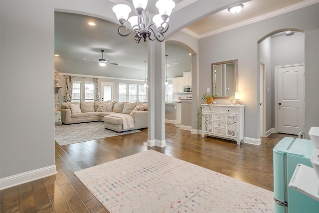 201 Saxon St, Waxahachie, TX 75165 - living room featuring arched walkways, ceiling fan, crown molding, dark wood finished floors, and a chandelier
