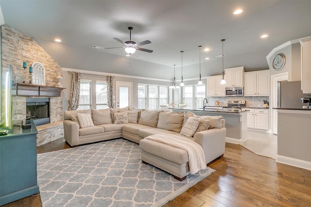 201 Saxon St, Waxahachie, TX 75165 - living area featuring a stone fireplace, light wood-style flooring, a ceiling fan, and recessed lighting