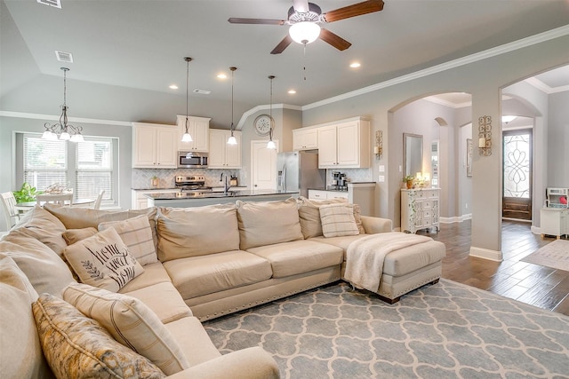 201 Saxon St, Waxahachie, TX 75165 - living area featuring ceiling fan, arched walkways, healthy amount of natural light, wood finished floors, and ornamental molding