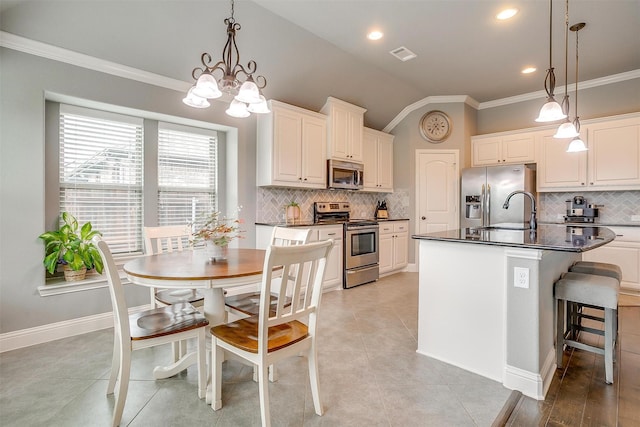 201 Saxon St, Waxahachie, TX 75165 - kitchen with stainless steel appliances, dark countertops, backsplash, crown molding, and lofted ceiling