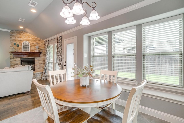 201 Saxon St, Waxahachie, TX 75165 - tiled dining space featuring lofted ceiling, ornamental molding, a fireplace, and a chandelier