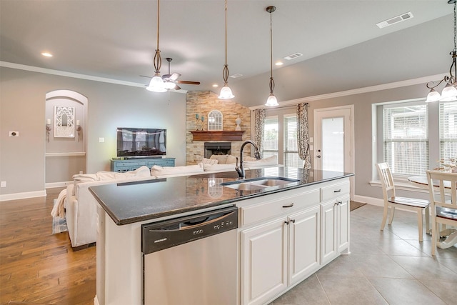 201 Saxon St, Waxahachie, TX 75165 - kitchen featuring dishwasher, a fireplace, a ceiling fan, open floor plan, and ornamental molding