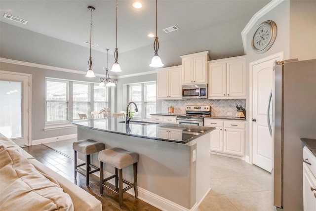 201 Saxon St, Waxahachie, TX 75165 - kitchen featuring stainless steel appliances, tasteful backsplash, a kitchen bar, ornamental molding, and dark countertops