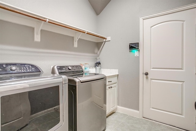 201 Saxon St, Waxahachie, TX 75165 - laundry area with washing machine and dryer, cabinet space, and light tile patterned floors
