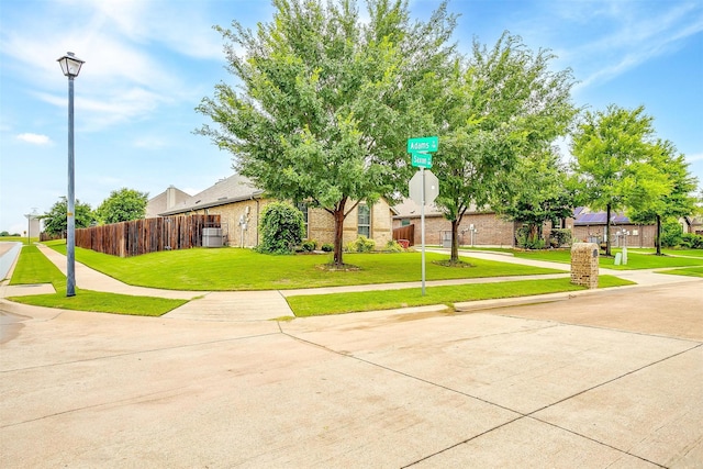 201 Saxon St, Waxahachie, TX 75165 - obstructed view of property featuring brick siding