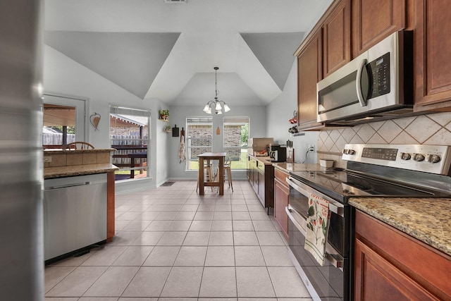 905 Austin Acre, Sulphur Springs, TX 75482 - kitchen featuring stainless steel appliances, backsplash, vaulted ceiling, light tile patterned flooring, and a chandelier