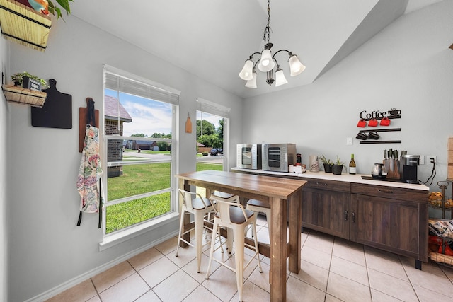 905 Austin Acre, Sulphur Springs, TX 75482 - dining area featuring light tile patterned flooring, vaulted ceiling, and a chandelier
