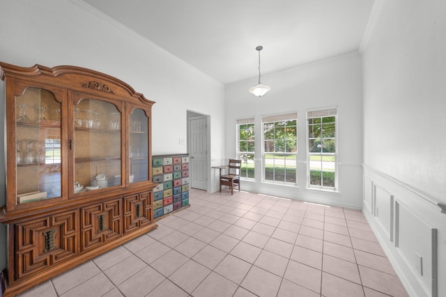 905 Austin Acre, Sulphur Springs, TX 75482 - dining space with light tile patterned flooring, crown molding, and a wainscoted wall