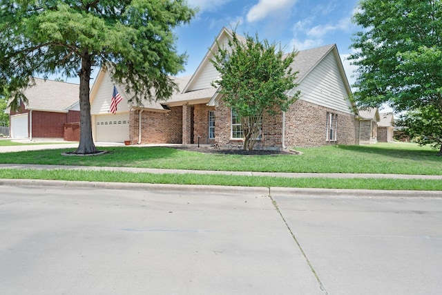 905 Austin Acre, Sulphur Springs, TX 75482 - view of front of property with an attached garage, brick siding, and a front yard