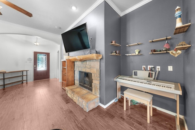 905 Austin Acre, Sulphur Springs, TX 75482 - living room featuring arched walkways, wood finished floors, ornamental molding, and a stone fireplace