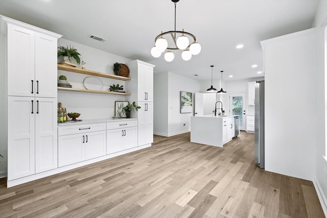 826 W Canty St, Dallas, TX 75208 - kitchen featuring light countertops, appliances with stainless steel finishes, white cabinetry, light wood finished floors, and recessed lighting