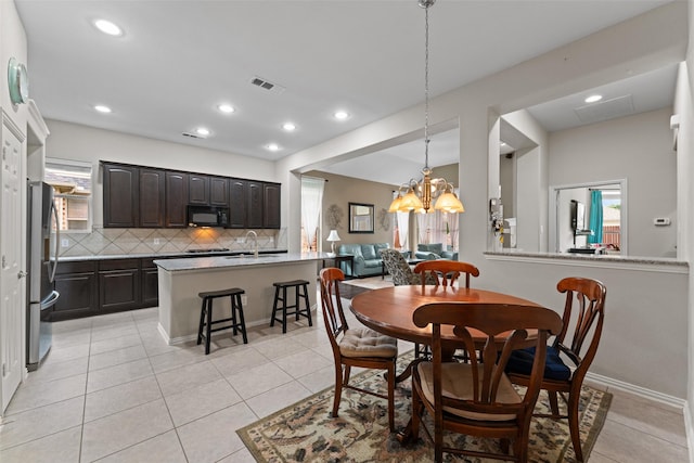 209 Willet Ct, Little Elm, TX 75068 - dining area featuring light tile patterned flooring, a chandelier, and recessed lighting