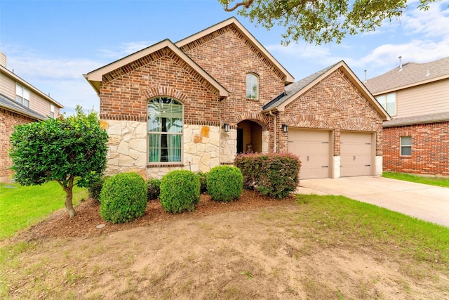 209 Willet Ct, Little Elm, TX 75068 - view of front of property with brick siding, an attached garage, concrete driveway, stone siding, and a front lawn