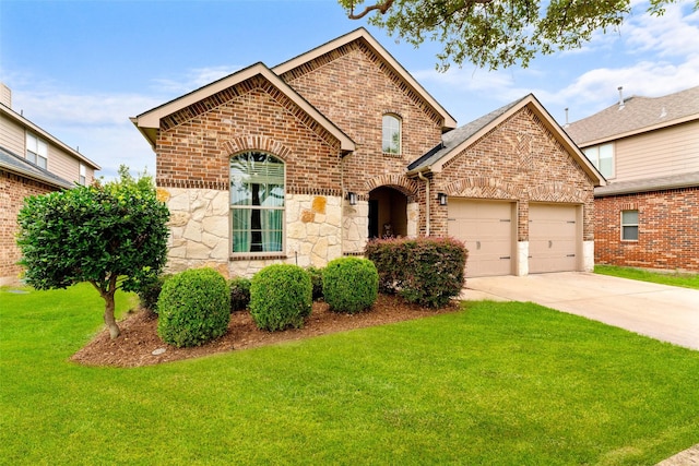209 Willet Ct, Little Elm, TX 75068 - view of front of home featuring brick siding, a garage, a front lawn, driveway, and stone siding