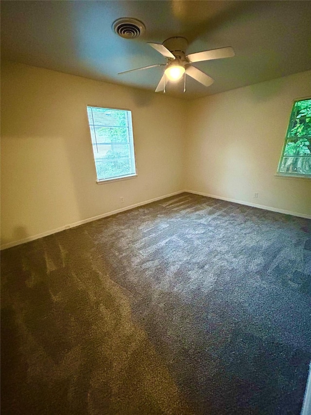 128 Robert St, Burleson, TX 76028 - empty room featuring dark carpet and ceiling fan