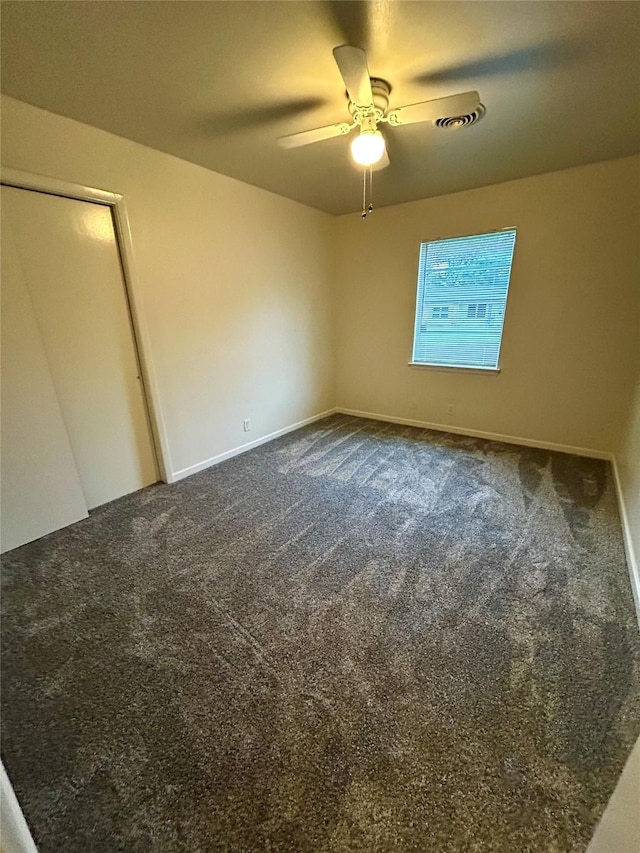 128 Robert St, Burleson, TX 76028 - unfurnished bedroom featuring dark colored carpet and a ceiling fan