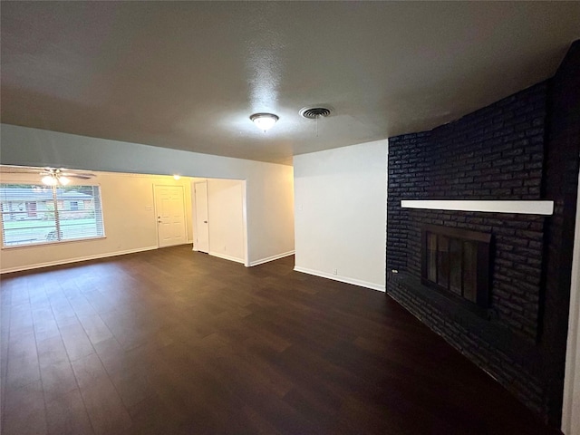 128 Robert St, Burleson, TX 76028 - unfurnished living room featuring dark wood finished floors, a fireplace, and ceiling fan