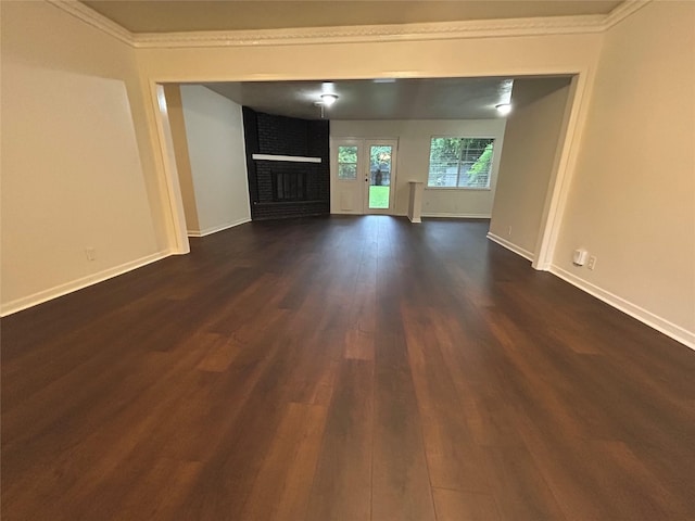 128 Robert St, Burleson, TX 76028 - unfurnished living room with dark wood finished floors, a brick fireplace, and ornamental molding