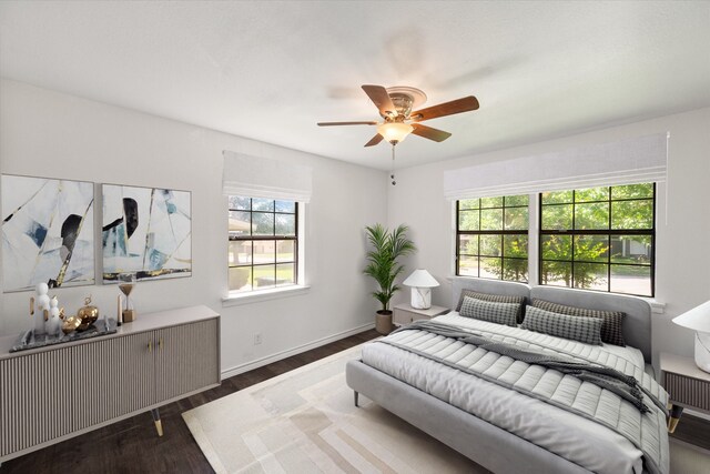 612 Elm St, Hurst, TX 76053 - bedroom featuring dark wood finished floors, ceiling fan, and radiator heating unit
