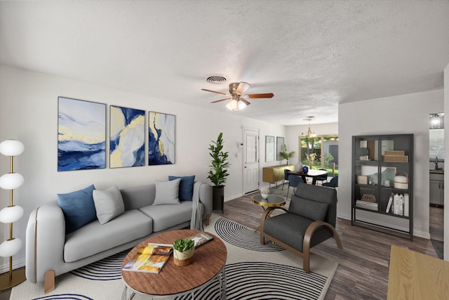 612 Elm St, Hurst, TX 76053 - living area with wood finished floors, ceiling fan, and a textured ceiling